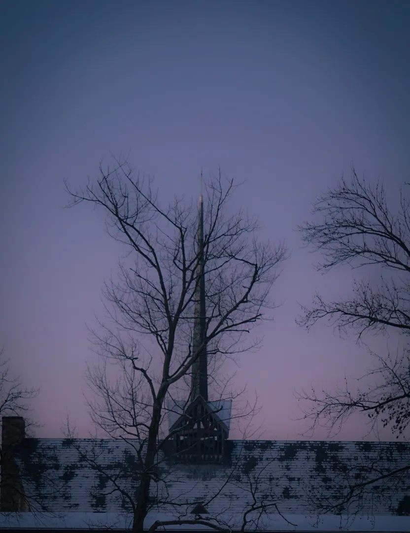 A church spire seen through bare winter branches against a mauve twilight sky